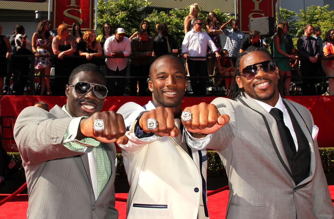 Charlie Peprah, Jarrett Bush and Desmond Bishop show off their 2011 Super Bowl rings for the Green Bay Packers.