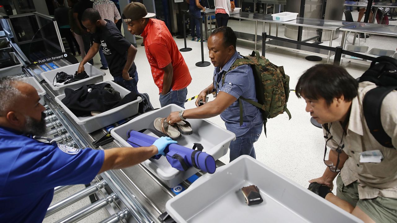 MIAMI, FL - OCTOBER 24:  Travelers use the automated screening lanes funded by American Airlines and installed by the Transportation Security Administration
at Miami International Airport on October 24, 2017 in Miami, Florida. The automated checkpoint technology, which is now in use at 11 airports across the country, is said by officials with the Transportation Security Administration to enhance security efficiency as well as decrease the amount of time spent in the security screening process.  (Photo by Joe Raedle/Getty Images)