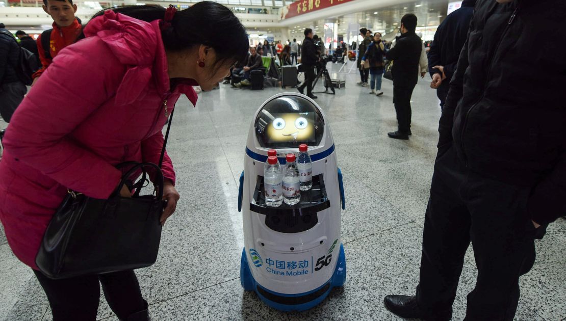 A 5G robot serves free bottles of water at East Railway Station in Hangzhou in China's eastern Zhejiang province on the first day of the 2019 Spring Festival travel rush.  