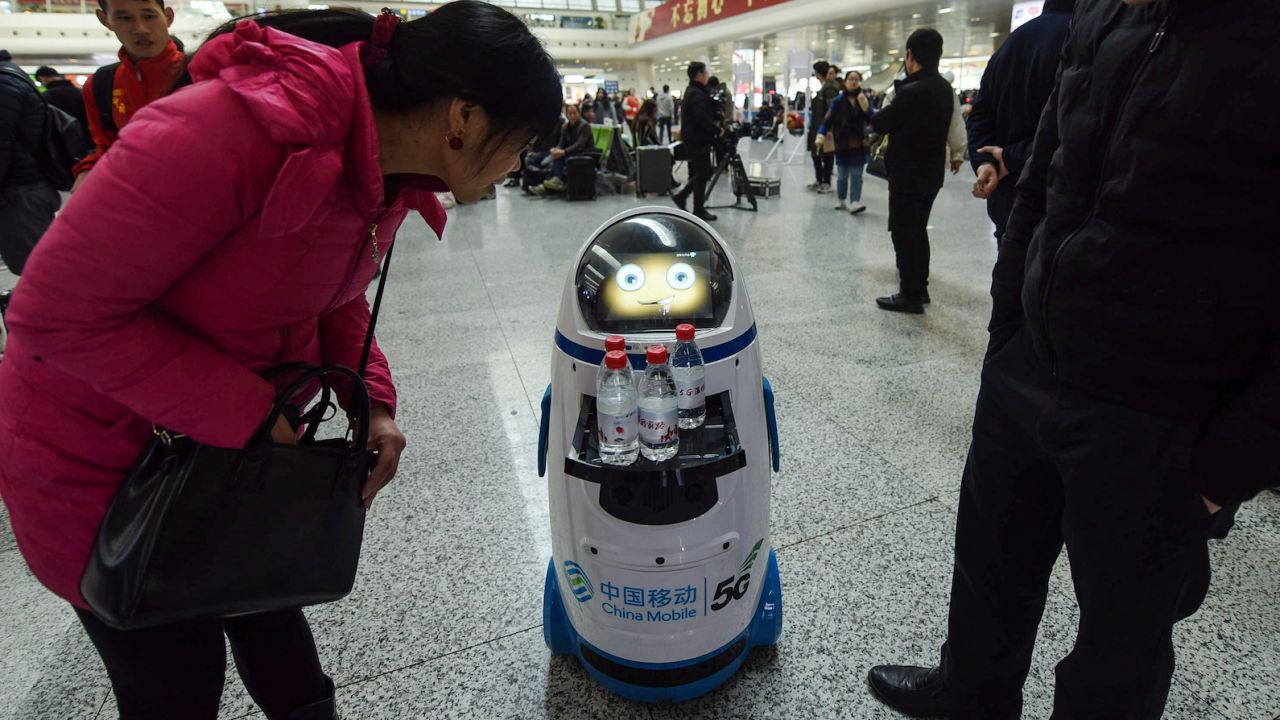 A 5G robot serves free bottles of water at East Railway Station in Hangzhou in China's eastern Zhejiang province on the first day of the 2019 Spring Festival travel rush.  