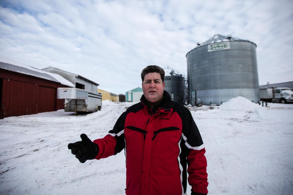 Dave Walton says problems from the shutdown come in the wake of steel tariffs that raised the price of grain bins, like the one seen behind him.