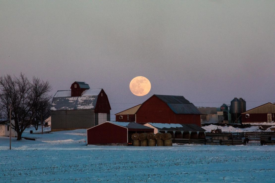 The wolf moon over farm buildings near Olin, Iowa. 