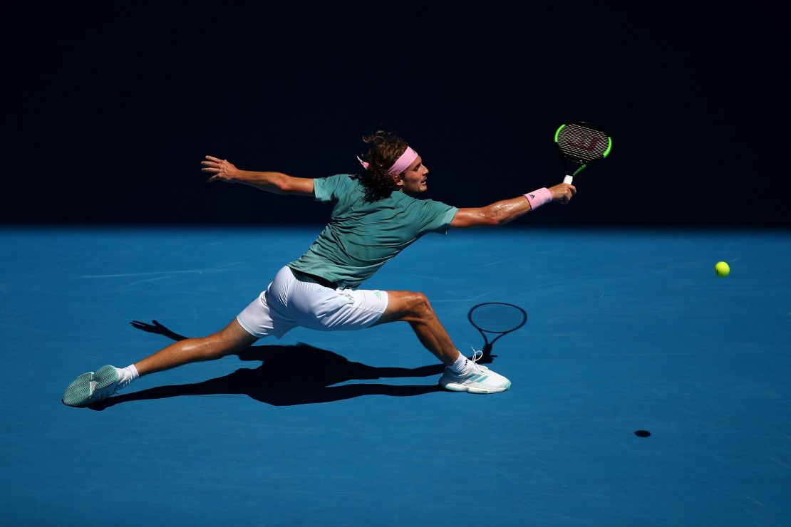 Stefanos Tsitsipas stretches for a backhand at the Australian Open. 