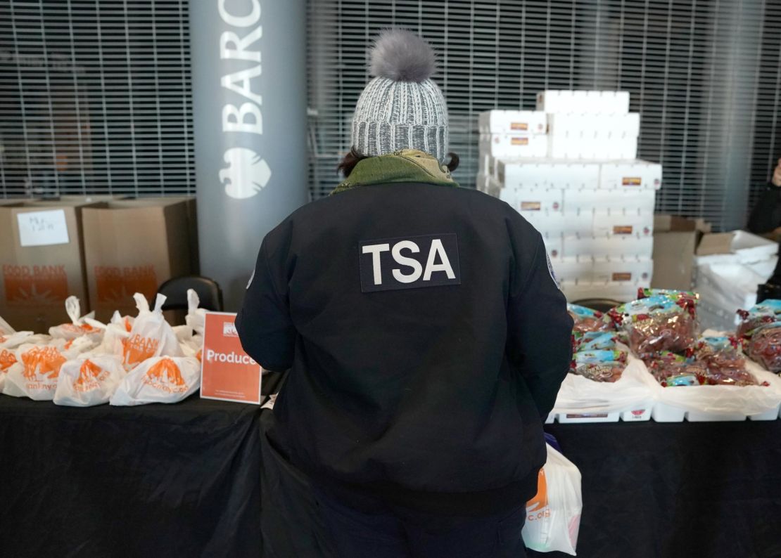 A furloughed Transportation Security Administration (TSA) employee looks at food at the Barclays Center as the Food Bank For NYC holds food distribution for federal workers impacted by the government shutdown.