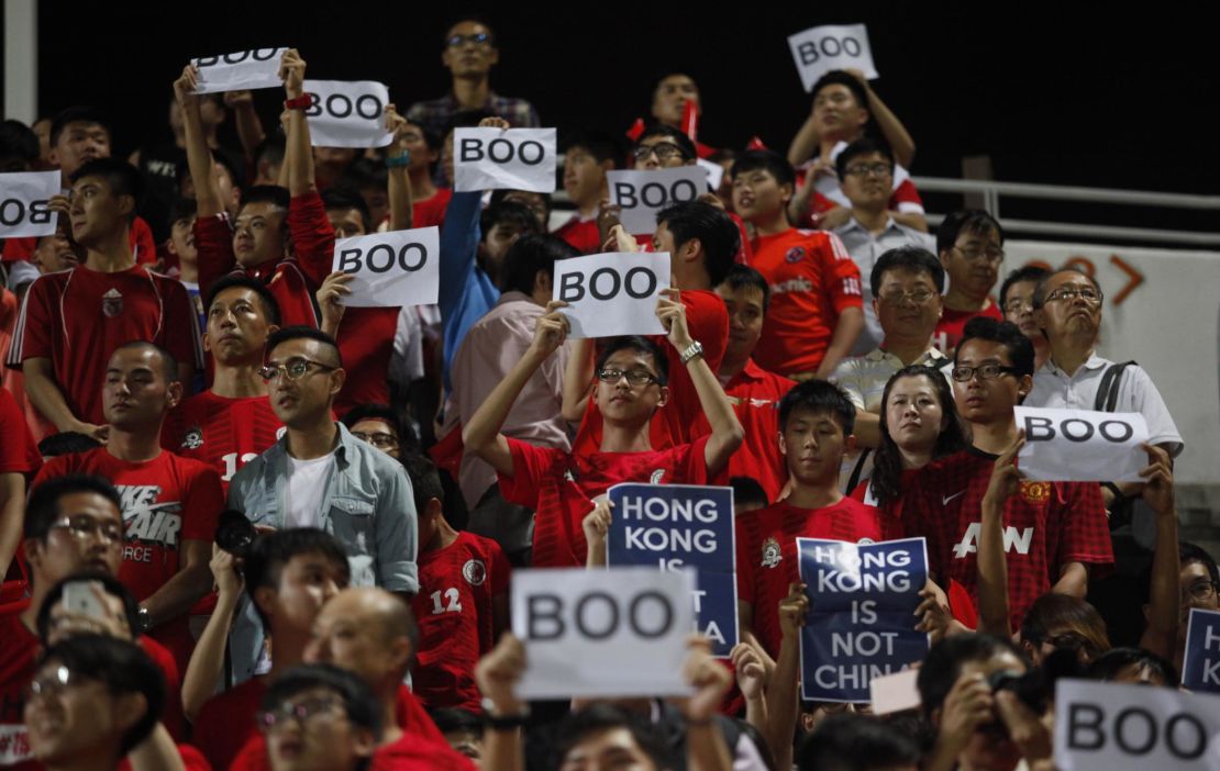 Hong Kong fans hold up signs that read "Boo" while the national anthem was being played during a world cup qualifier at Mong Kok stadium in Hong Kong on November 17, 2015.