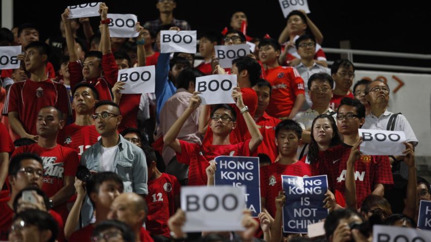Hong Kong fans hold up signs that read "Boo" while the national anthem was being played during a world cup qualifier at Mong Kok stadium in Hong Kong on November 17, 2015. Hong Kong fans booed the anthem they share with China on Tuesday while some turned their backs and held up "boo" signs in a show of defiance before a crunch World Cup football qualifier with their mainland rivals.. AFP PHOTO / ISAAC LAWRENCE        (Photo credit should read Isaac Lawrence/AFP/Getty Images)