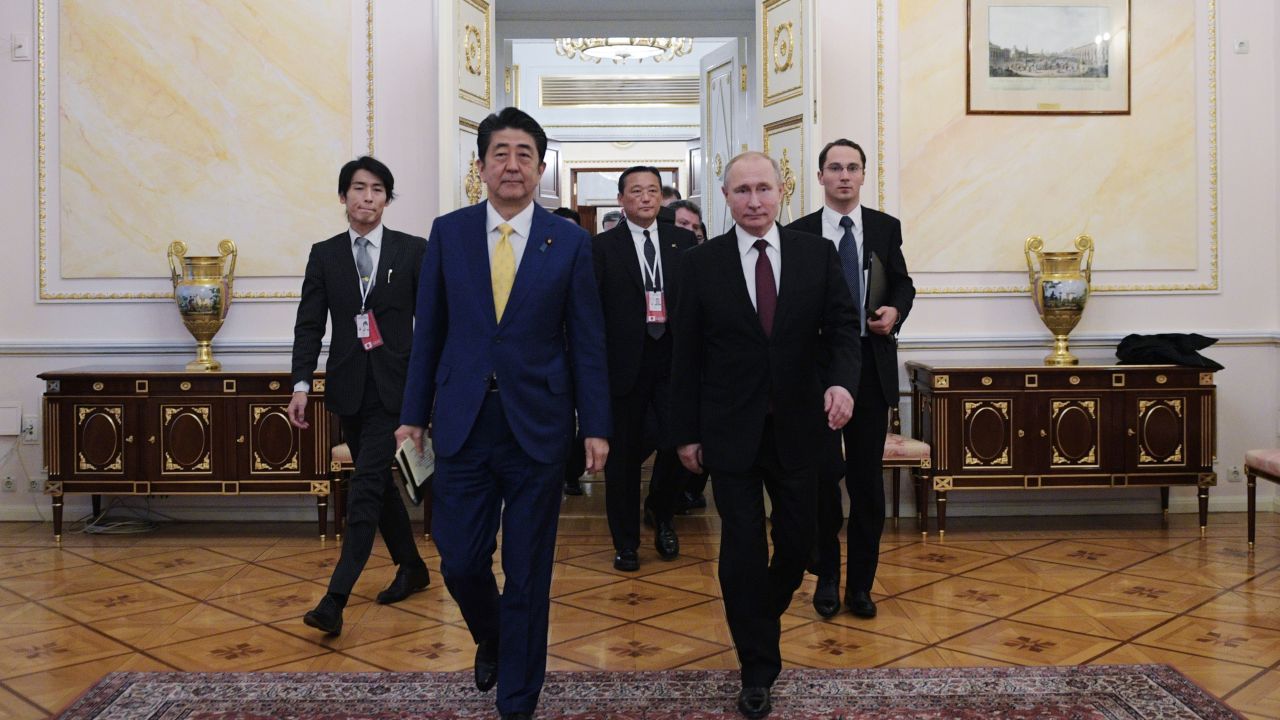 Russian President Vladimir Putin and Japanese Prime Minister Shinzo Abe walk during their meeting at the Kremlin in Moscow. 