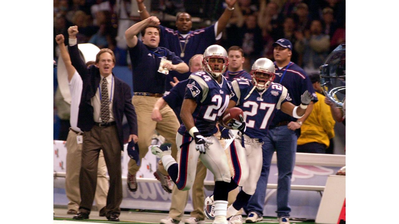 Patriots corner back Ty Law after intercepting Warner's pass during first-half action.