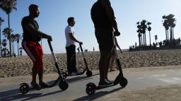 LOS ANGELES, CA - AUGUST 13:  People ride Bird shared dockless electric scooters along Venice Beach on August 13, 2018 in Los Angeles, California. Shared e-scooter startups Bird and Lime have rapidly expanded in the city. Some city residents complain the controversial e-scooters are dangerous for pedestrians and sometimes clog sidewalks. A Los Angeles Councilmember has proposed a ban on the scooters until regulations can be worked out.  (Photo by Mario Tama/Getty Images)