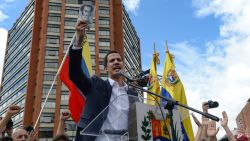 Venezuela's National Assembly head Juan Guaido speaks to the crowd during a mass opposition rally against leader Nicolas Maduro in which he declared himself the country's "acting president", on the anniversary of a 1958 uprising that overthrew military dictatorship, in Caracas on January 23, 2019. - "I swear to formally assume the national executive powers as acting president of Venezuela to end the usurpation, (install) a transitional government and hold free elections," said Guaido as thousands of supporters cheered. Moments earlier, the loyalist-dominated Supreme Court ordered a criminal investigation of the opposition-controlled legislature. (Photo by Federico PARRA / AFP)        (Photo credit should read FEDERICO PARRA/AFP/Getty Images)