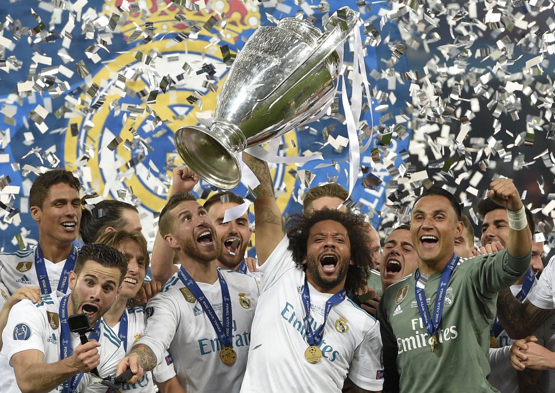  Real Madrid's Brazilian defender Marcelo (C) lifts the trophy after winning the 2018 Champions League.