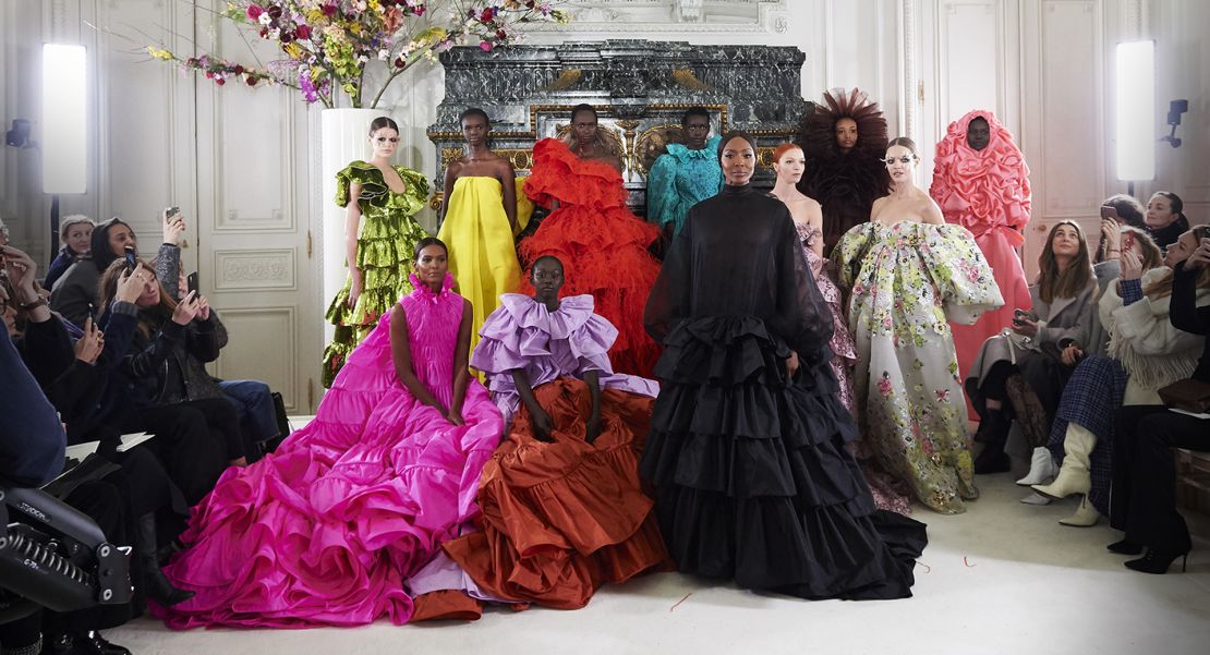 Adut stands (top far right) alongside fellow models including Naomi Campbell (center) during Valentino's couture show in Paris.