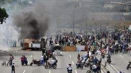 Venezuelan opposition demonstrators set up a barricade to block a street, during a protest against the government of President Nicolas Maduro, on the anniversary of 1958 uprising that overthrew military dictatorship in Caracas on January 23, 2019. - Venezuela's National Assembly head Juan Guaido declared himself the country's "acting president" on Wednesday during a mass opposition rally against leader Nicolas Maduro. (Photo by Yuri CORTEZ / AFP)        (Photo credit should read YURI CORTEZ/AFP/Getty Images)
