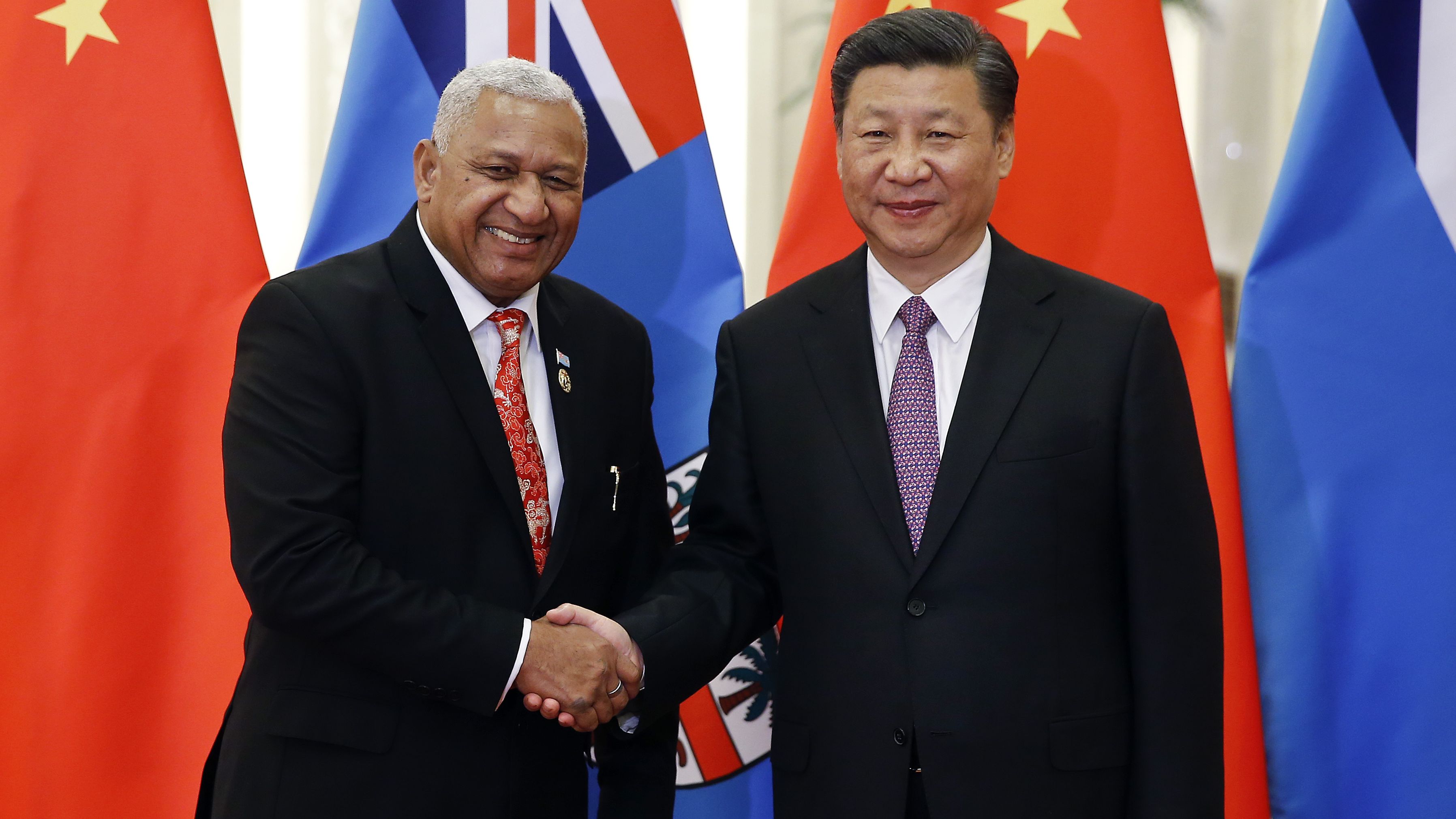 Fiji's Prime Minister Josaia Voreqe Bainimarama shakes hands with Chinese President Xi Jinping. Bainimarama has moved Fiji closer to Beijing. 