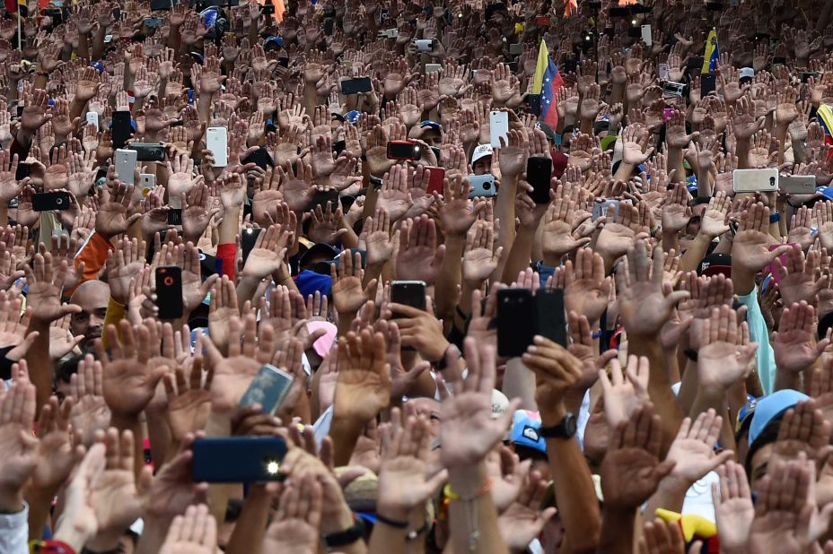 People raise their hands to show solidarity with Guaido, who was declaring himself interim president on January 23.