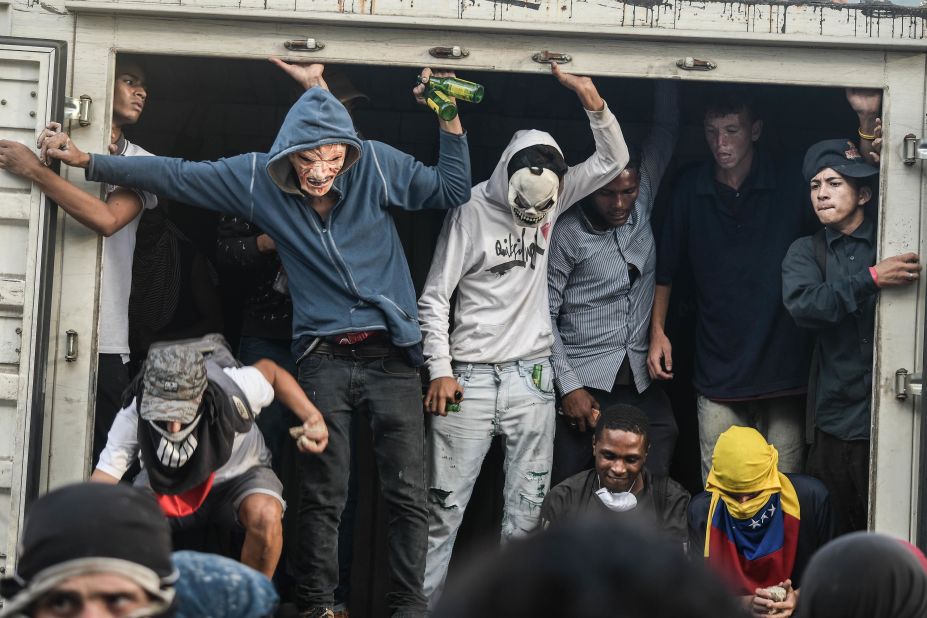 Protesters set up barricades to block a road in Caracas.