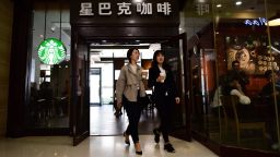 Two women walk out of a Starbucks coffee shop in Beijing. WANG ZHAO/AFP/Getty Images