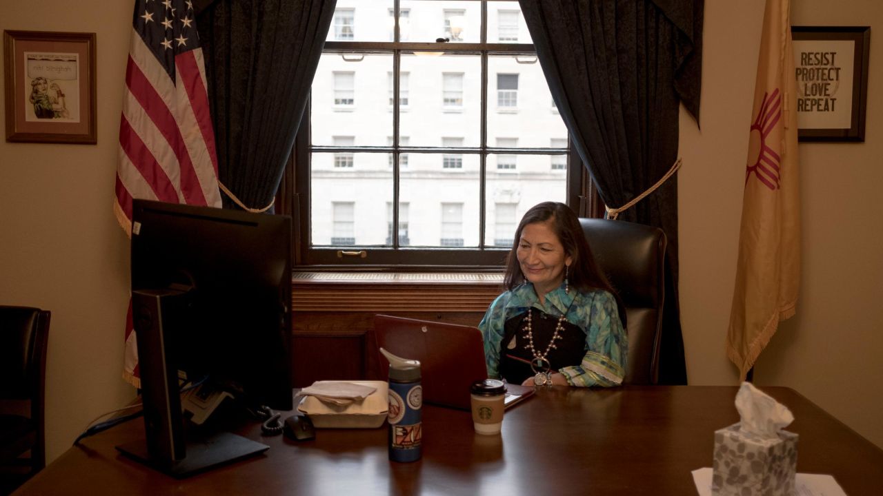 Haaland speaks to a reporter over a video conference call in her office.