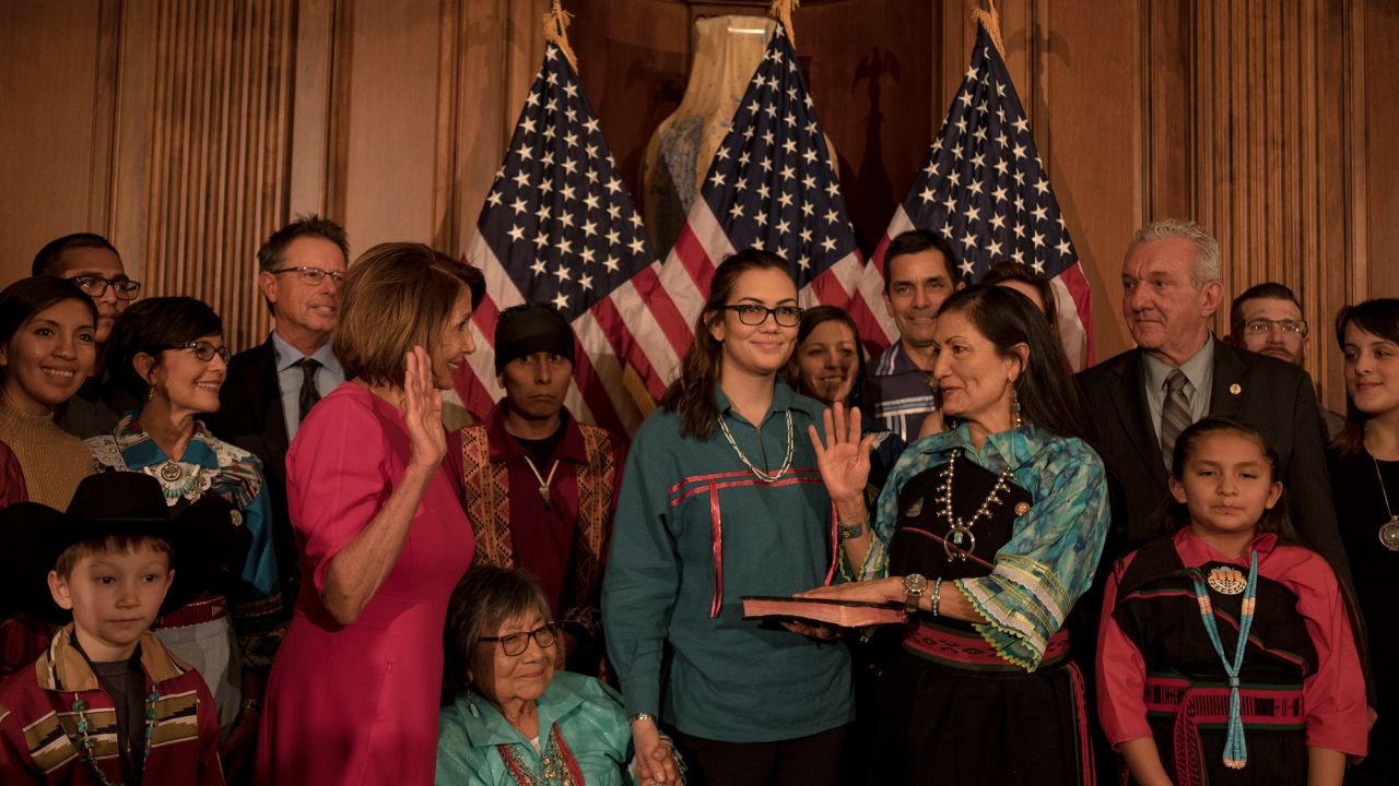 Haaland stands alongside her family and friends during the ceremonial swearing in with House Speaker Nancy Pelosi.