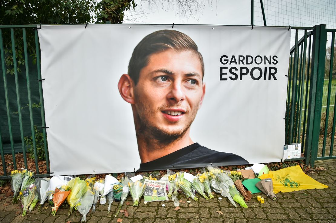 Flowers placed under a portrait of  Sala in Nantes.