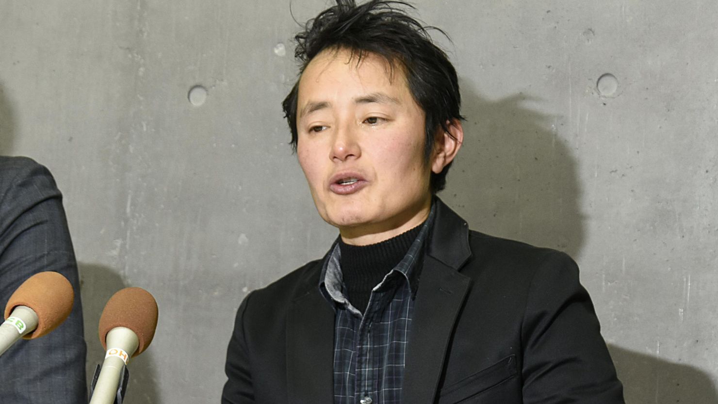 Takakito Usui speaks to reporters after the Supreme Court ruled a law that effectively forces trans people to be sterilized is "currently constitutional." The 45-year-old wished to register as a male without undergoing surgery.