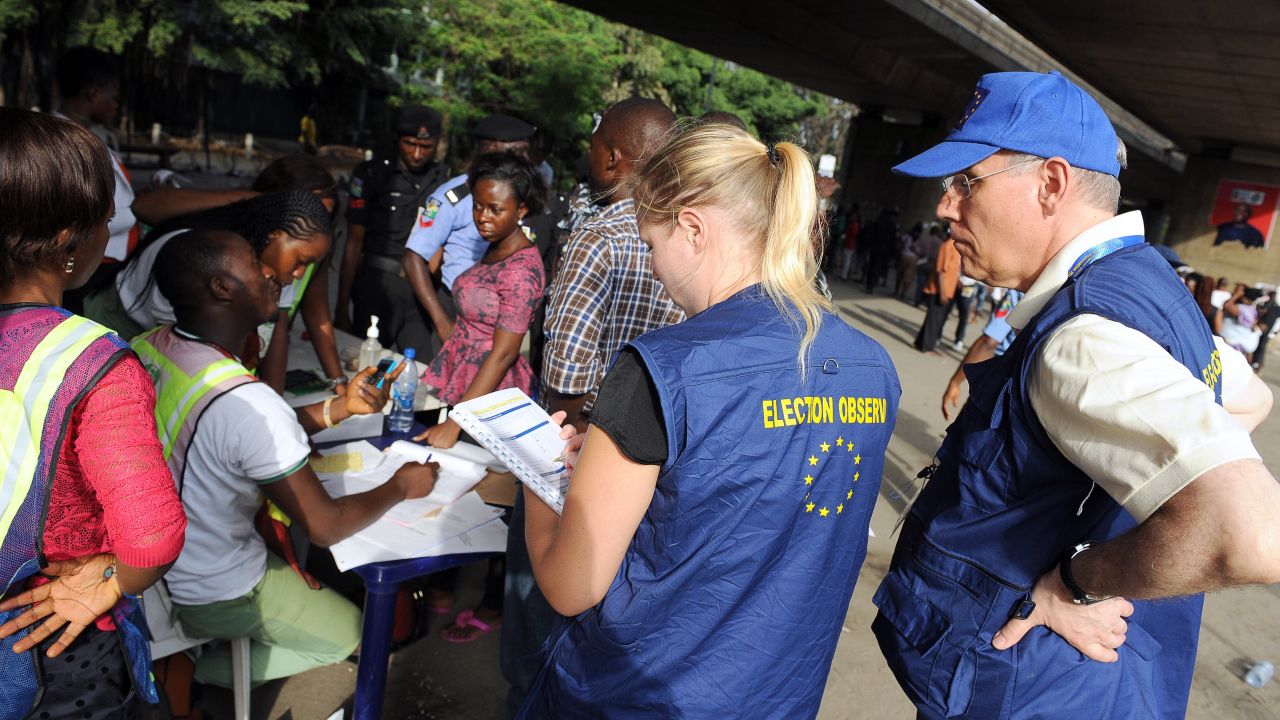 European Union observers take notes as officials of Independent National Electoral Commission (INEC) count ballots during gubernatorial and local assembly elections in Lagos on April 11, 2015. 