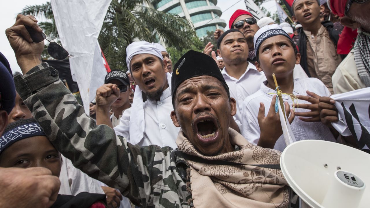 Members of various hardline Muslim groups celebrate after Jakarta's Governor was convicted of committing blasphemy on May 9, 2017 in Jakarta, Indonesia.