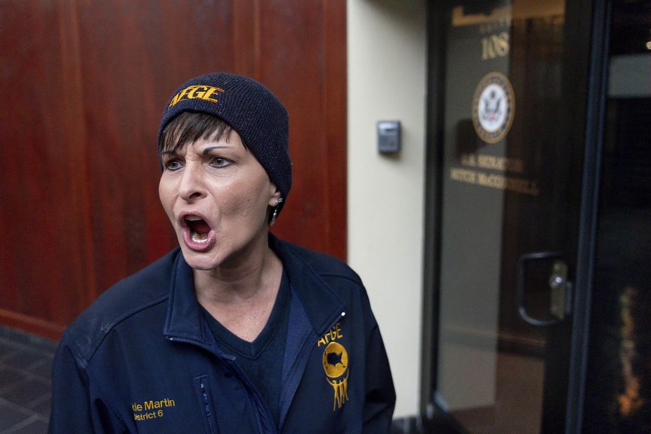 Vickie Martin, president of the American Federation of Government Workers Local 1438, reacts to the locked door of US Sen. Mitch McConnell's office in Lexington, Kentucky, during a January 23 protest.