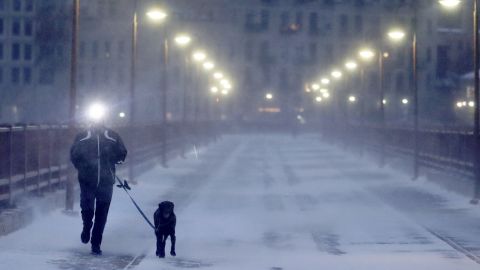 A runner and his dog brave frigid conditions Thursday while making their way east across the Stone Arch Bridge in Minneapolis.