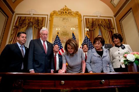 House Speaker Nancy Pelosi signs the deal to reopen the government on January 25. Democrats insisted throughout the shutdown that Trump should sign a measure to reopen the government before any border security negotiations could begin.