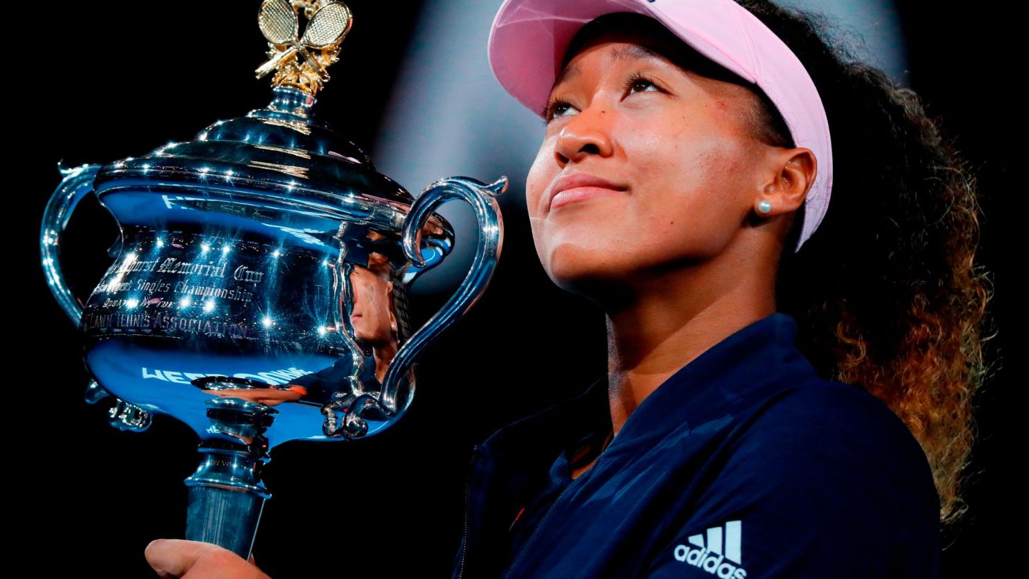 Japan's Naomi Osaka celebrates with the championship trophy during the presentation ceremony after her victory against Czech Republic's Petra Kvitova.
