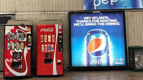 Pepsi Super Bowl ads surround Coca-Cola vending machines in Atlanta, GA.