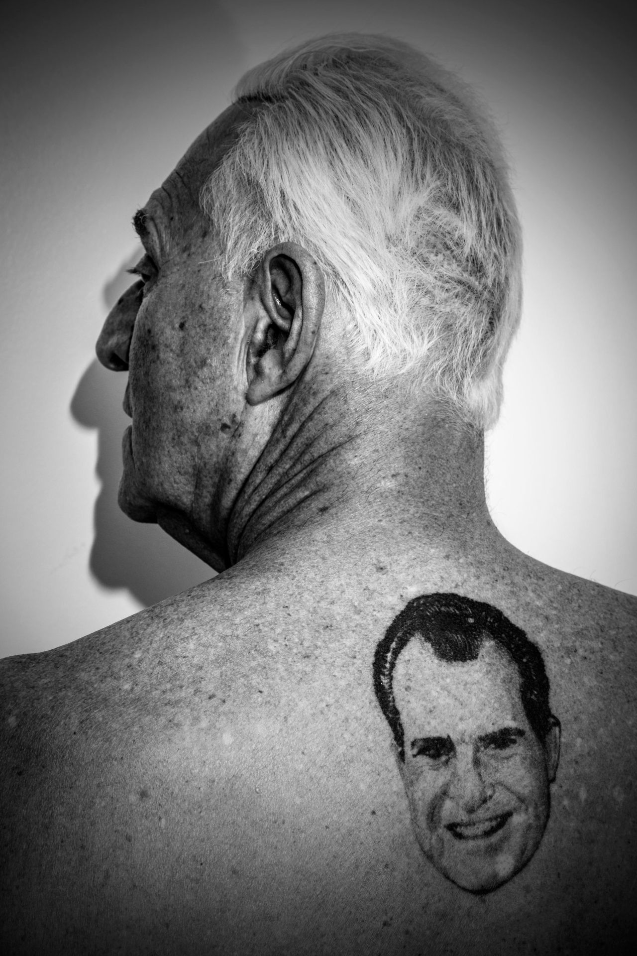 Stone shows a tattoo on his back of former President Nixon.