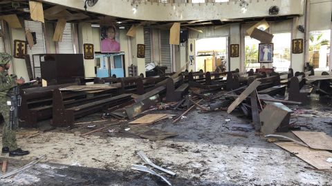 A soldier views the site inside a Roman Catholic cathedral in southern Philippines after two bombs exploded Sunday.