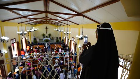 A Roman Catholic nun takes a photo with her phone at the Sacred Heart Church of Jesus in Sandino, Cuba. The church is the first new Catholic church to be built on the communist-run island since 1959.