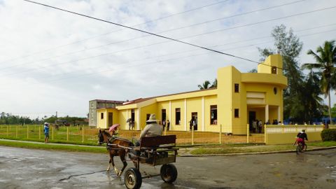 A horse and cart pass by the new church in Sandino, Cuba. The town in the early 1960's was notorious as a place where Cubans accused of helping anti-Castro rebels were sent to live in internal exile.