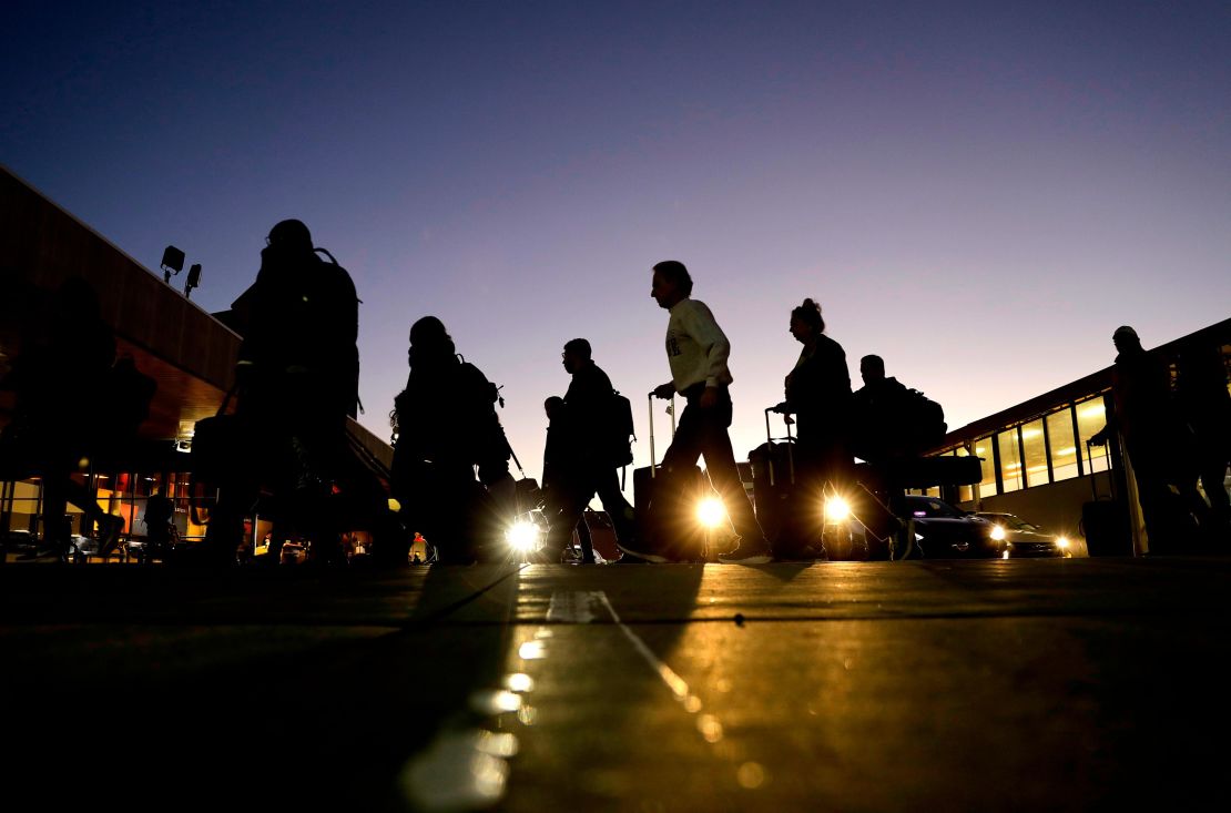 Travelers arrive to catch their flights at Hartsfield-Jackson Atlanta International Airport.