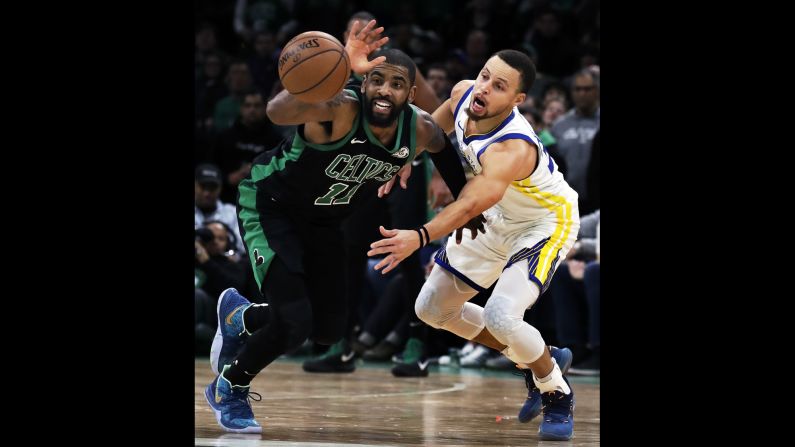 Golden State's Stephen Curry, right, tries to steal the ball from Boston's Kyrie Irving during an NBA game in Boston on Saturday, January 26.