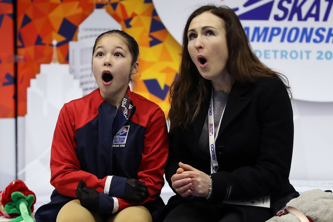 Alysa Liu and her coach Laura Lipetsky react after moving into first place after her Championship Ladies Free Skate.
