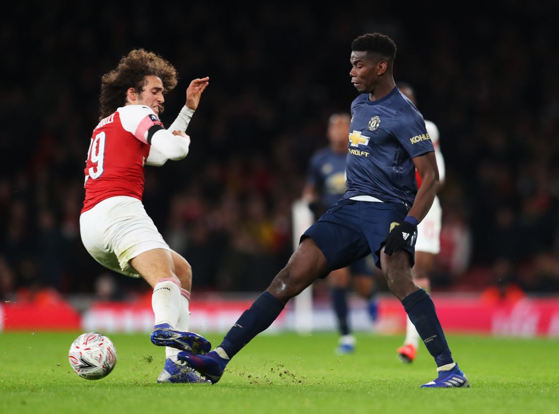 Paul Pogba of Manchester United is challenged by Arsenal's Matteo Guendouzi.