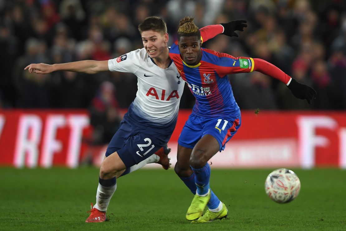 Spurs' Juan Foyth tangles with Wilfried Zaha of Crystal Palace.
