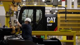 An employee assembles an excavator at a Caterpillar Inc. manufacturing facility in Victoria, Texas, on August 7, 2018.