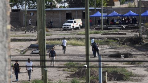 Police work in the lot next to the home of Gilad Pereg, where the bodies of his mother and aunt were found in Mendoza, Argentina, on Saturday.