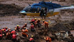 A helicopter provides support to the work of rescuers and firefighters in the search for victims, four days after the collapse of a dam at an iron-ore mine belonging to Brazil's giant mining company Vale near the town of Brumadinho, state of Minas Gerias, southeastern Brazil, on January 28, 2019.