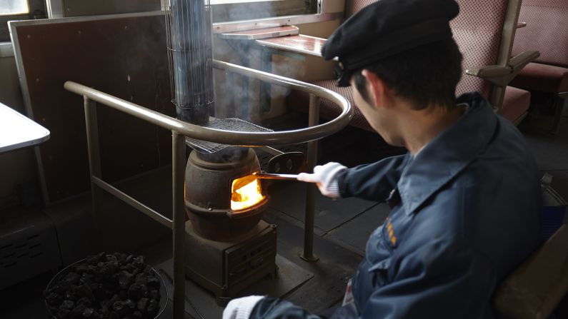 <strong>Old school heaters:  </strong>Conductors warm the 1950s-era passenger car by burning embers in potbelly stoves at either end of the train. 