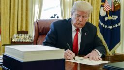 U.S. President Donald Trump signs a tax-overhaul bill into law in the Oval Office of the White House in Washington, D.C., U.S., on Friday, Dec. 22, 2017. This week House Republicans passed the most extensive rewrite of the U.S. tax code in more than 30 years, hours after the Senate passed the legislation, handing Trump his first major legislative victory providing a permanent tax cut for corporations and shorter-term relief for individuals. Photographer: Mike Theiler/Pool via Bloomberg