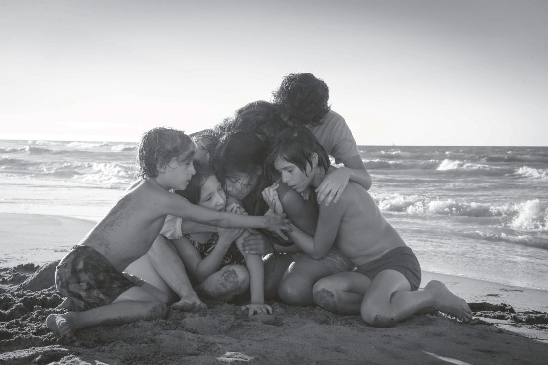 Cleo on the beach surrounded by the family she cares for. The image became key art for "Roma's" marketing campaign.