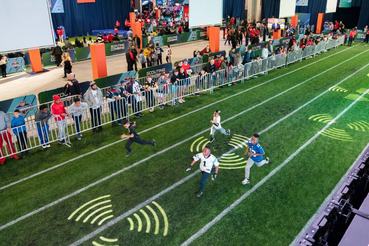 Attendees at the Super Bowl Experience in the Georgia World Congress Center watch as Landen Davis, 10 (top, wearing black), Braelin Talley, 9 (white shirt, no number), Shane Pollock, 9 (#1 jersey) and Evan Murunga, 9 (#13 jersey) run the 40-yard dash on Sunday. The boys are all from Atlanta. "I wanted them to have an NFL experience, to take advantage of this while it's here," said Steve Pollock, father of Shane.