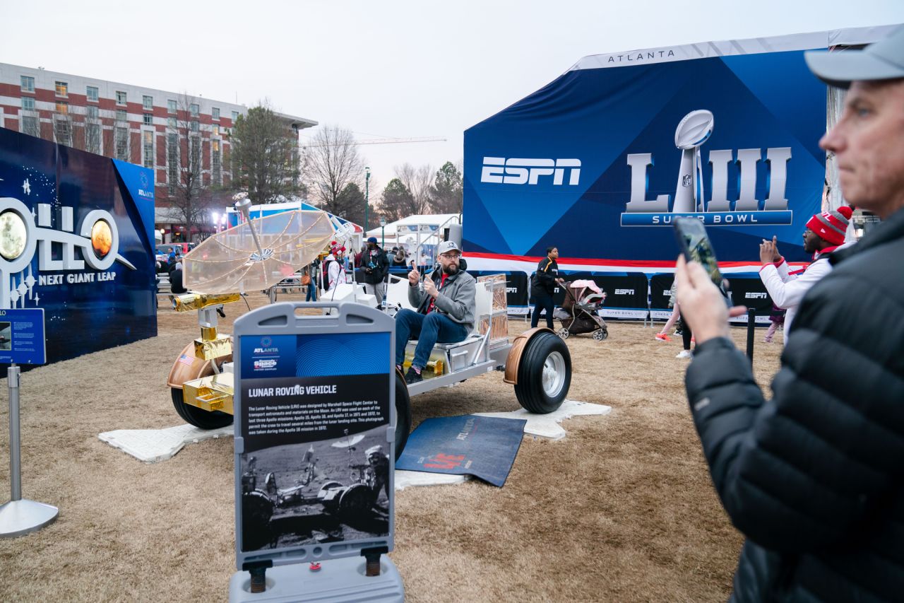 John Dingfelder, from Atlanta, poses for a photo in a lunar replica vehicle at the free Super Bowl LIVE event in Centennial Park. "I'm going out of town next weekend (the weekend of the game) so I wanted to see it all before leaving," he said.