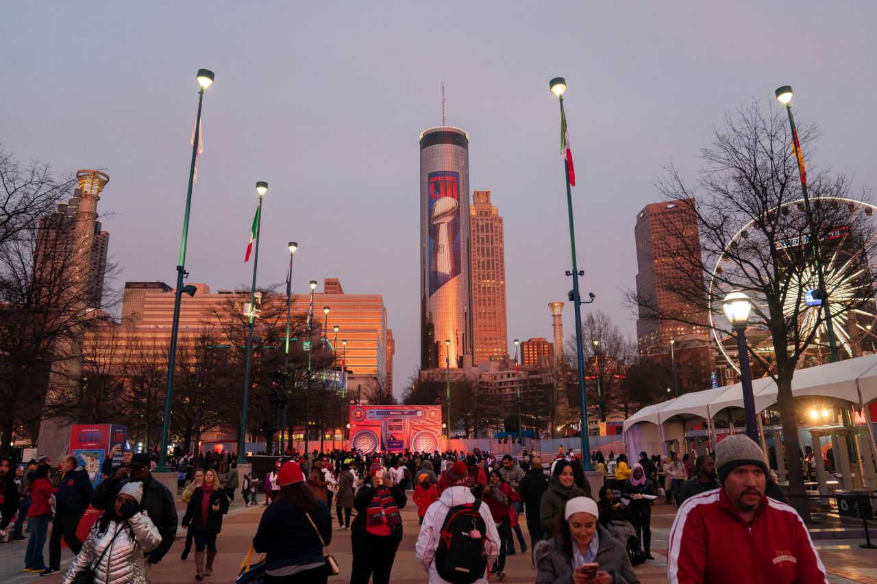 Downtown Atlanta, including a giant mural on the Westin hotel, as seen from Super Bowl LIVE in Centennial Park. The downtown park also served as a gathering place when Atlanta hosted the 1996 Summer Olympics.